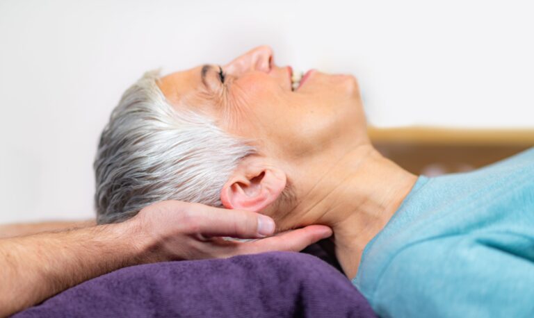 Osteopath treating migraine sufferer
